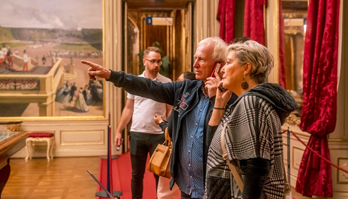 Visitors exploring an ornate room during the Schonbrunn Palace tour.