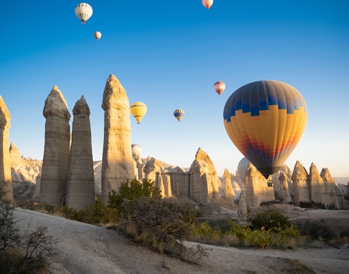 Hot air balloons over Cappadocia's unique rock formations, Turkey.