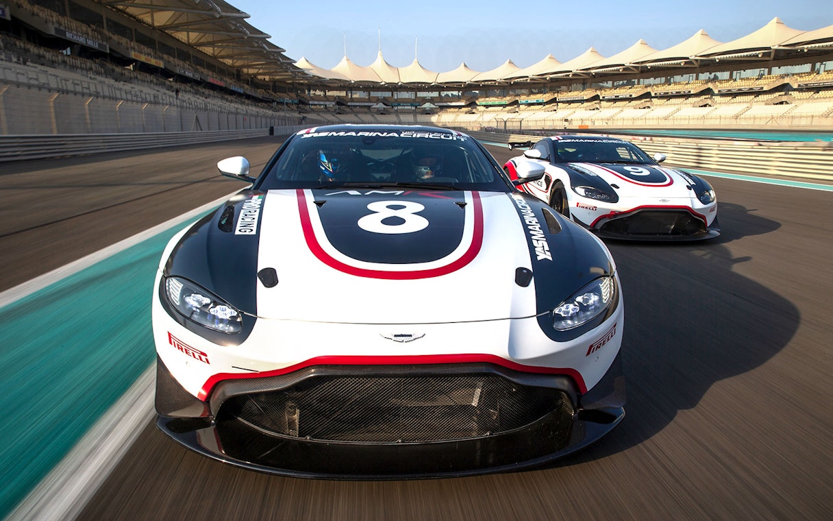 Aston Martin GT4 cars racing at Yas Marina Circuit.