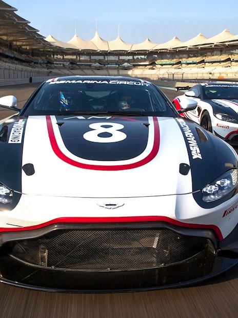 Aston Martin GT4 cars racing at Yas Marina Circuit.