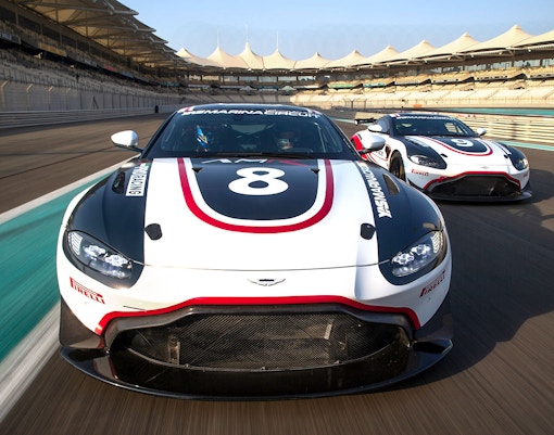 Aston Martin GT4 cars racing at Yas Marina Circuit.