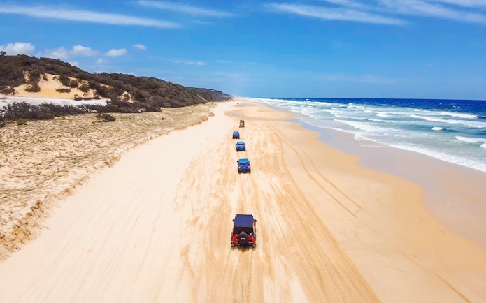 Four-wheel drive vehicles on K'gari beach, Fraser Island, Australia.