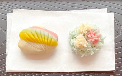 Japanese traditional sweets wagashi with colorful designs on a white napkin.