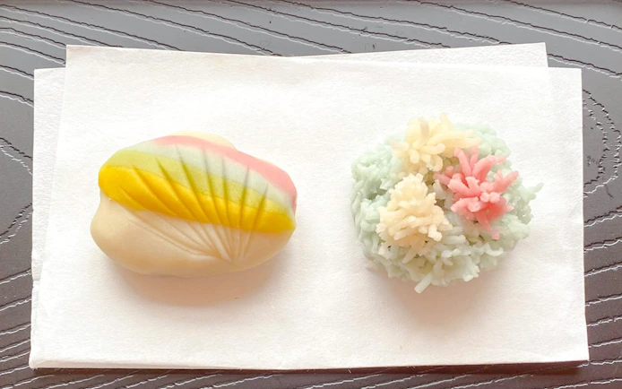 Japanese traditional sweets wagashi with colorful designs on a white napkin.