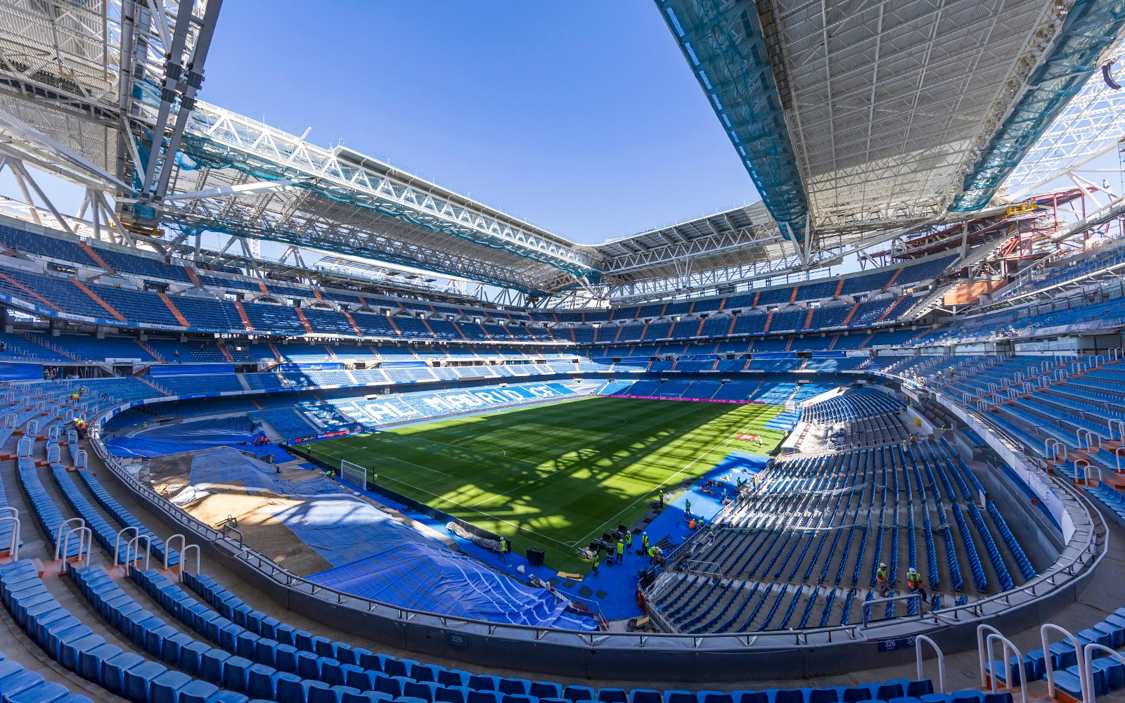 Santiago Bernabeu Stadium interior with empty seats and green field, Madrid.