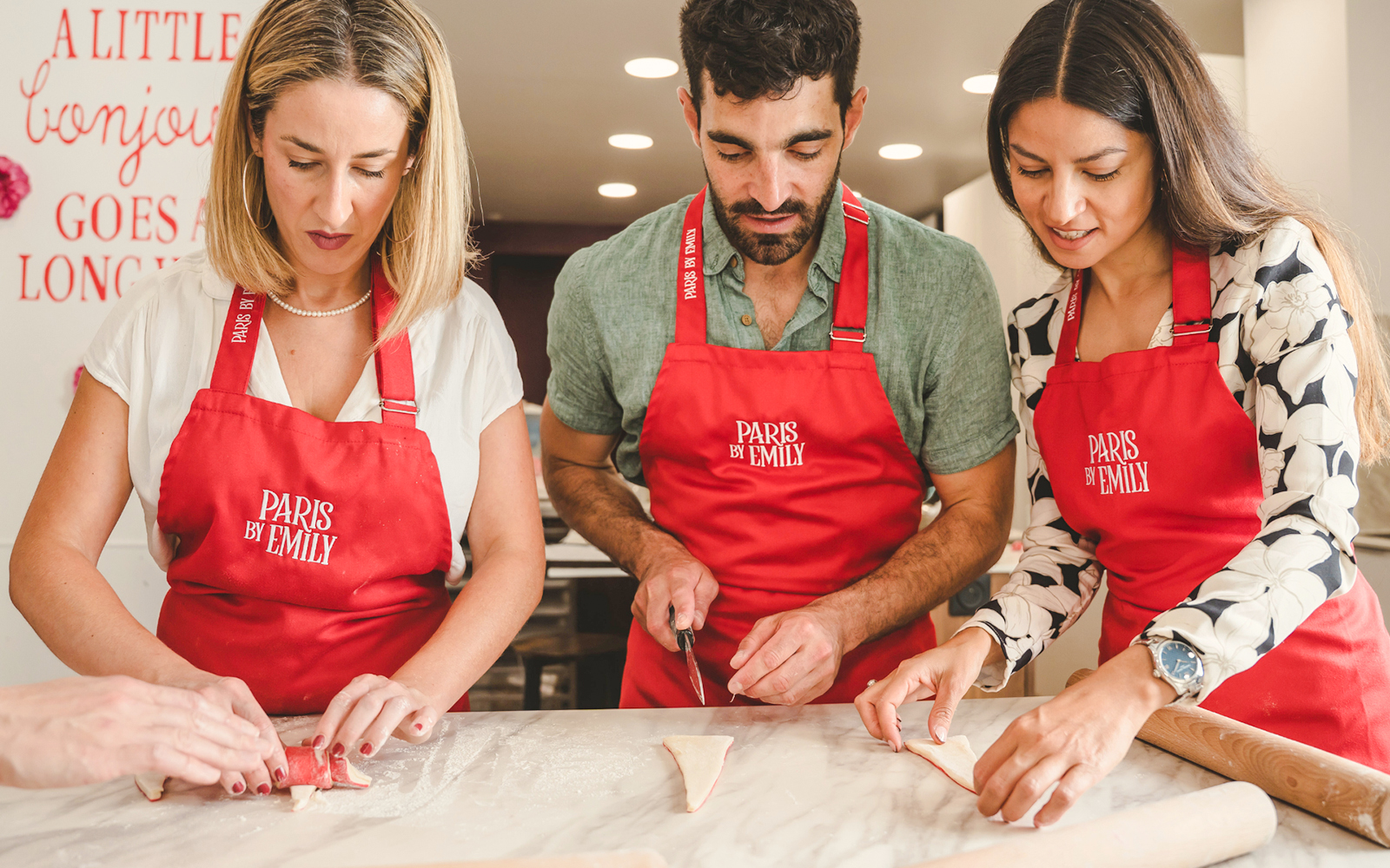 People making croissants at Emily in Paris Croissant-Making Workshop.