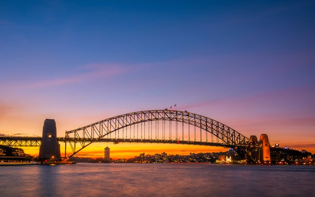 Sydney Harbour Bridge at sunset during a harbour cruise with refreshments.