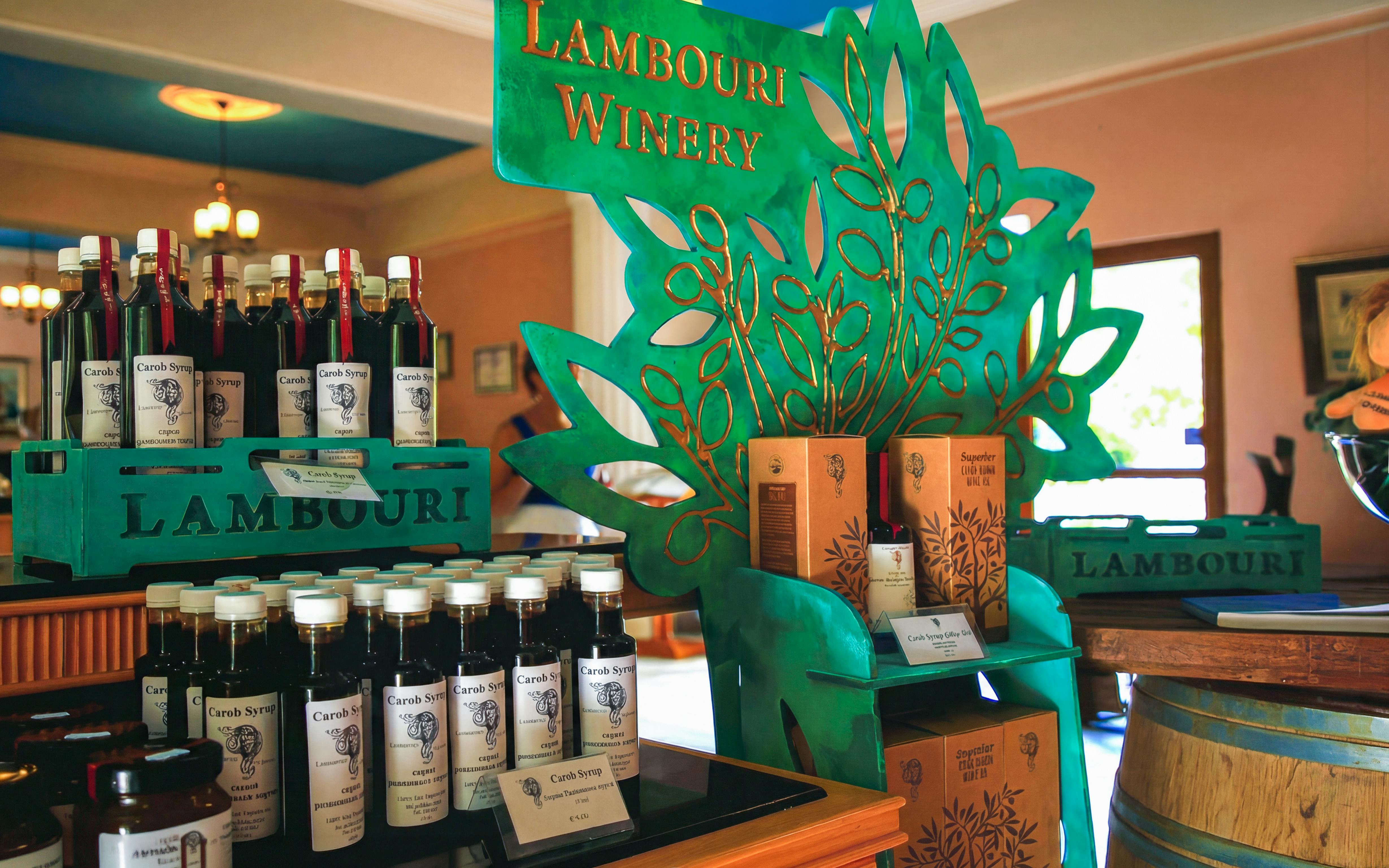 Lambouri Winery display with carob syrup bottles and wine boxes in Omodos.