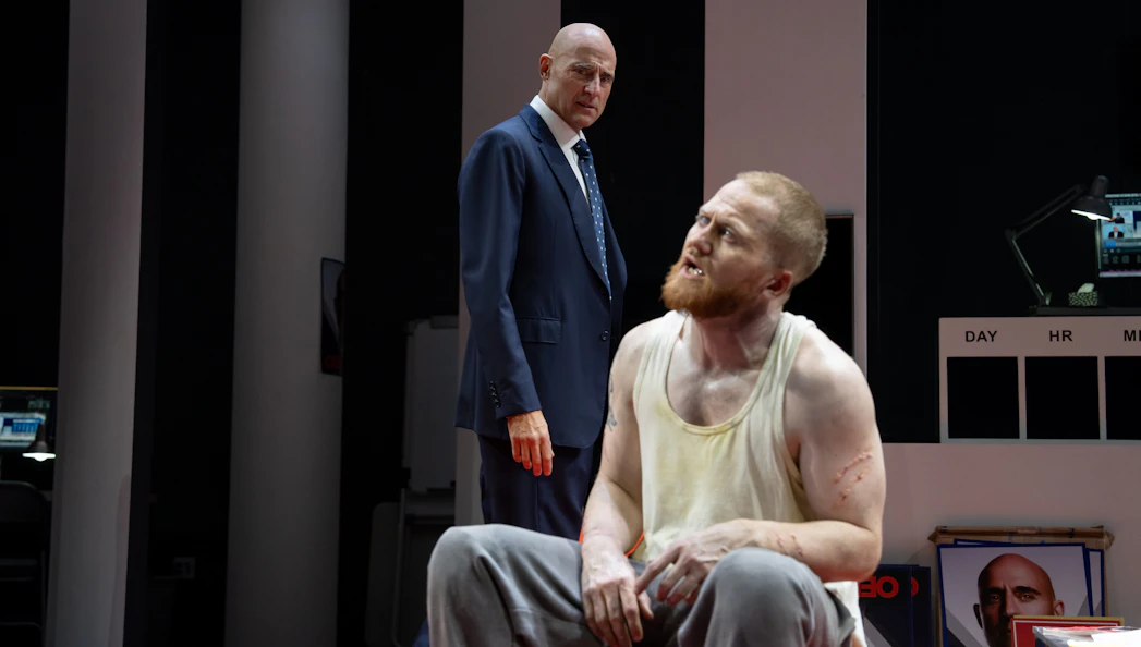 Stage scene from Oedipus Broadway show with two actors in dramatic interaction.