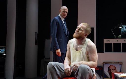 Stage scene from Oedipus Broadway show with two actors in dramatic interaction.