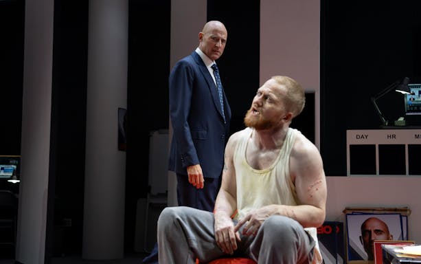 Stage scene from Oedipus Broadway show with two actors in dramatic interaction.