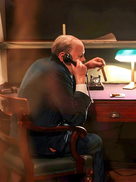 Man in historical office setting using a phone, part of Westminster Walking Tour & Churchill's War Rooms.