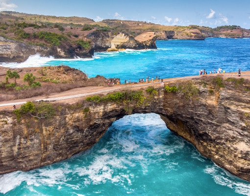 Group of tourists exploring the beautiful West Nusa Penida Island, Indonesia, with hotel transfers included in the tour package