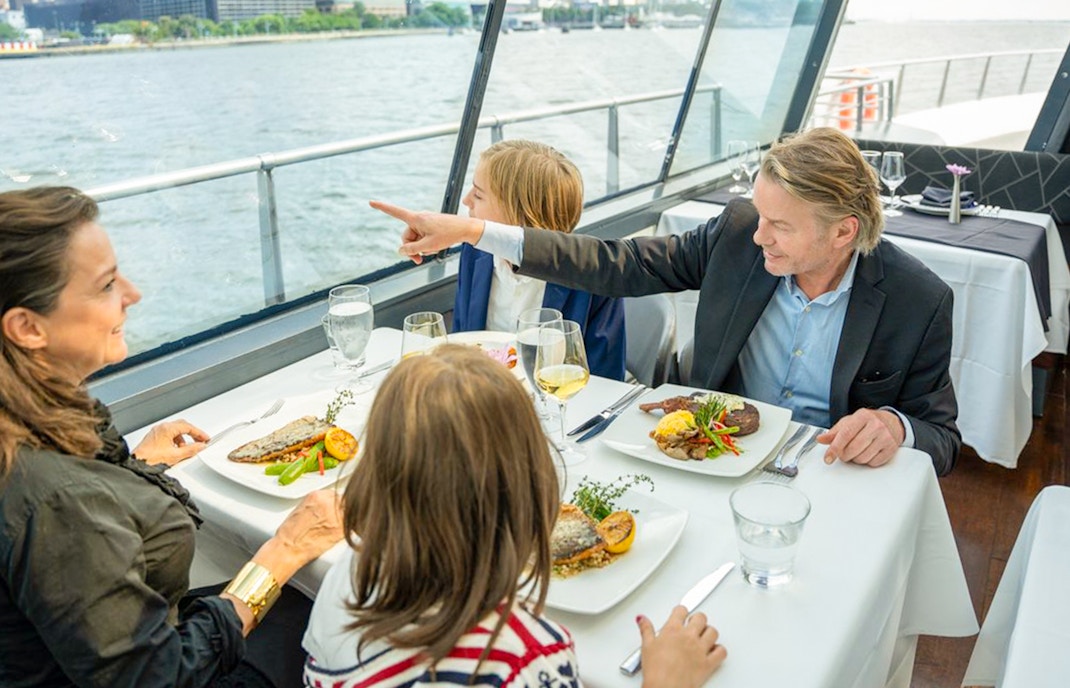 Bateaux New York Premier Lunch Cruise sailing past the iconic Statue of Liberty on a sunny day