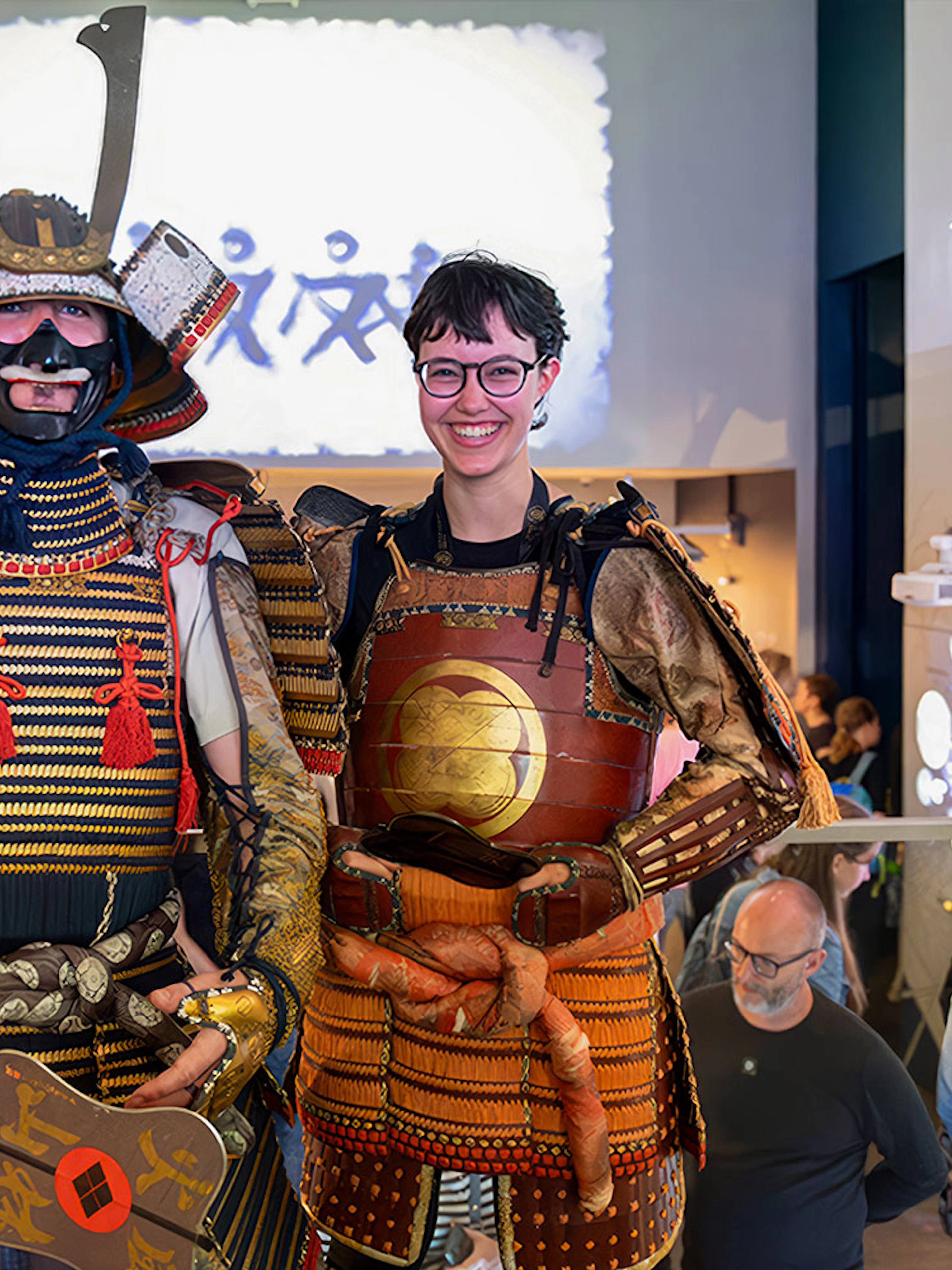 Samurai Museum visitors in traditional armor, Tokyo exhibit.