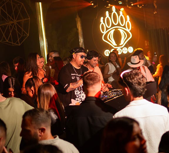 DJ performing at Baloo Ibiza nightclub with crowd enjoying the music.