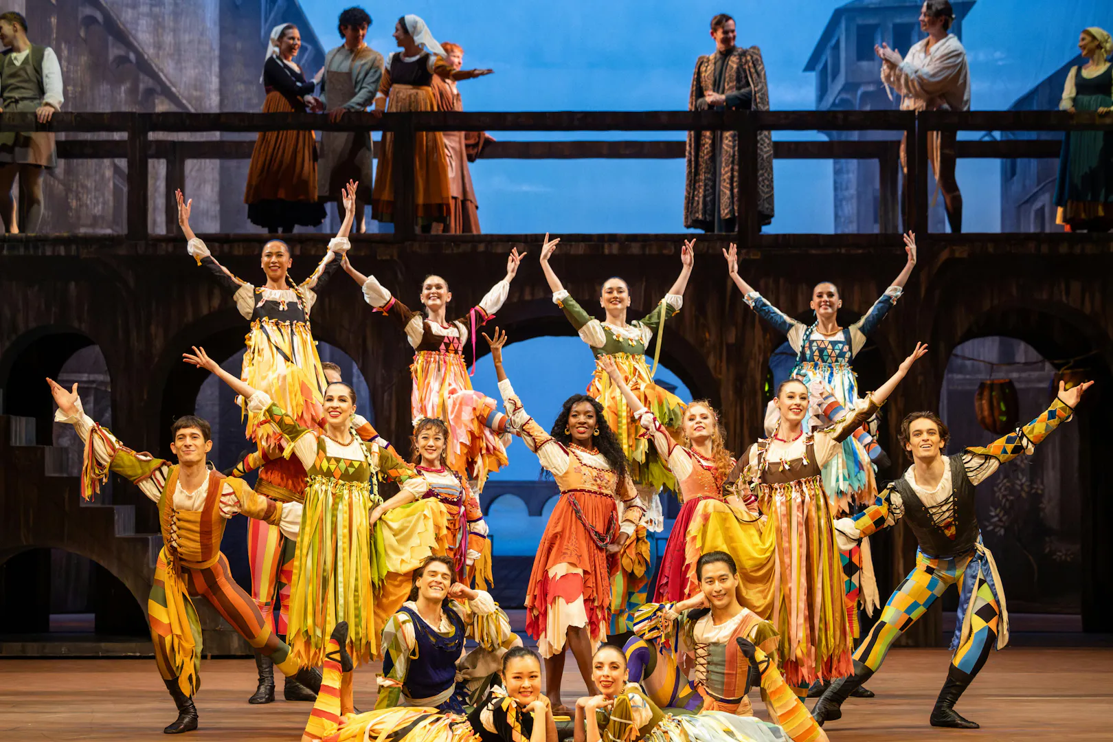 Australian Ballet dancers performing Romeo and Juliet on stage with vibrant costumes.