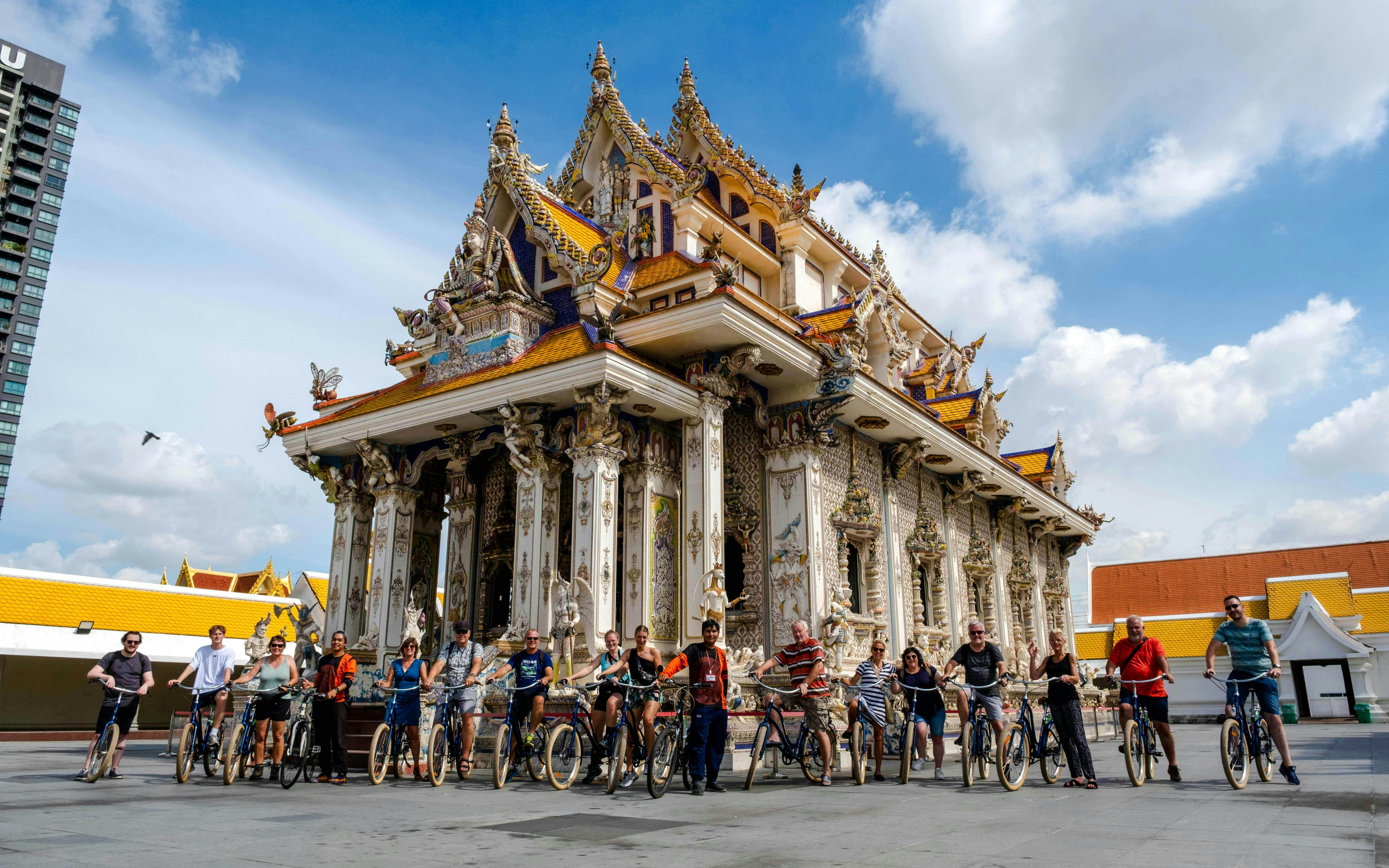 Cyclists in front of ornate temple during Bangkok Beyond Bicycle Ride.