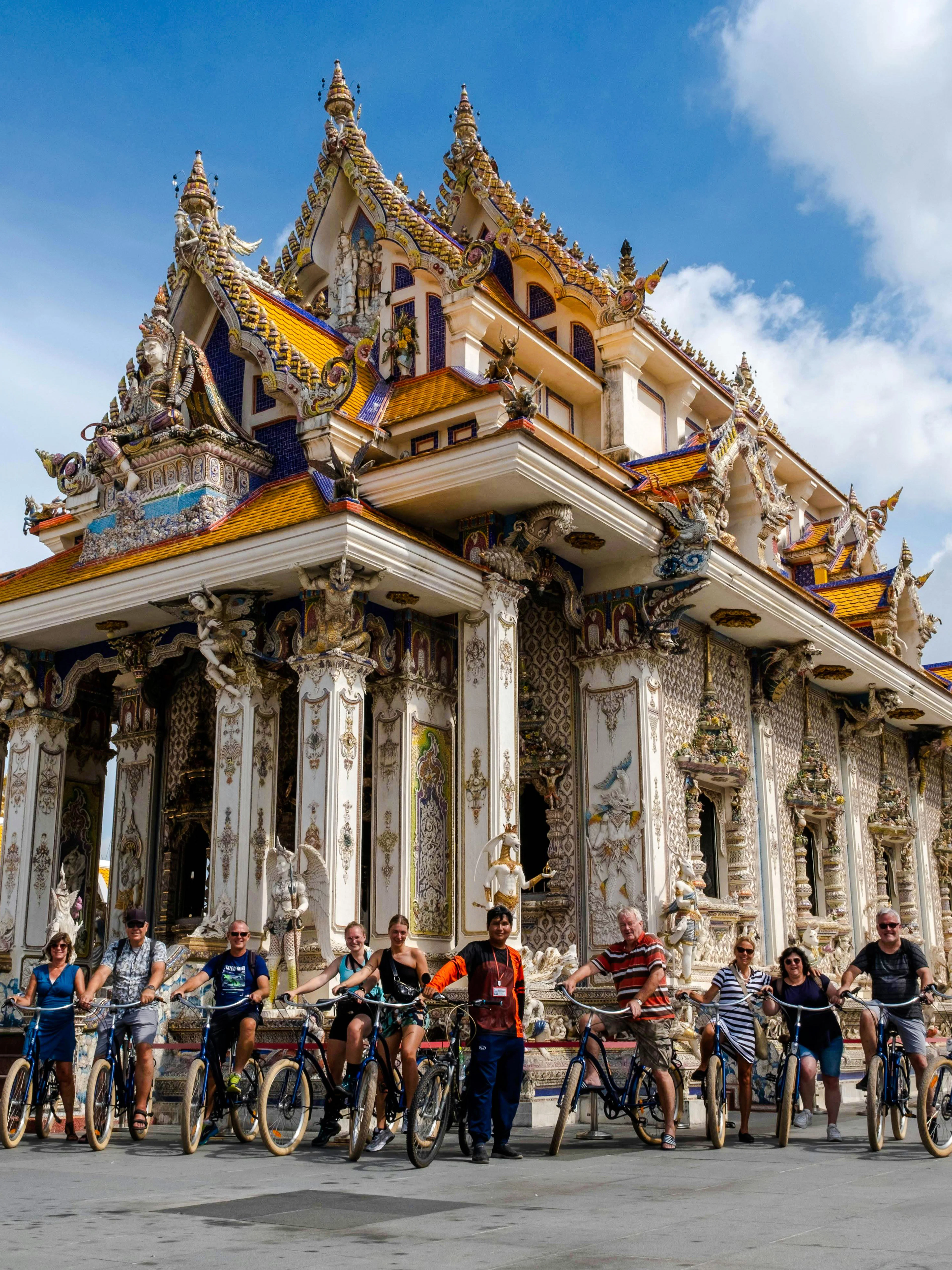 Cyclists in front of ornate temple during Bangkok Beyond Bicycle Ride.