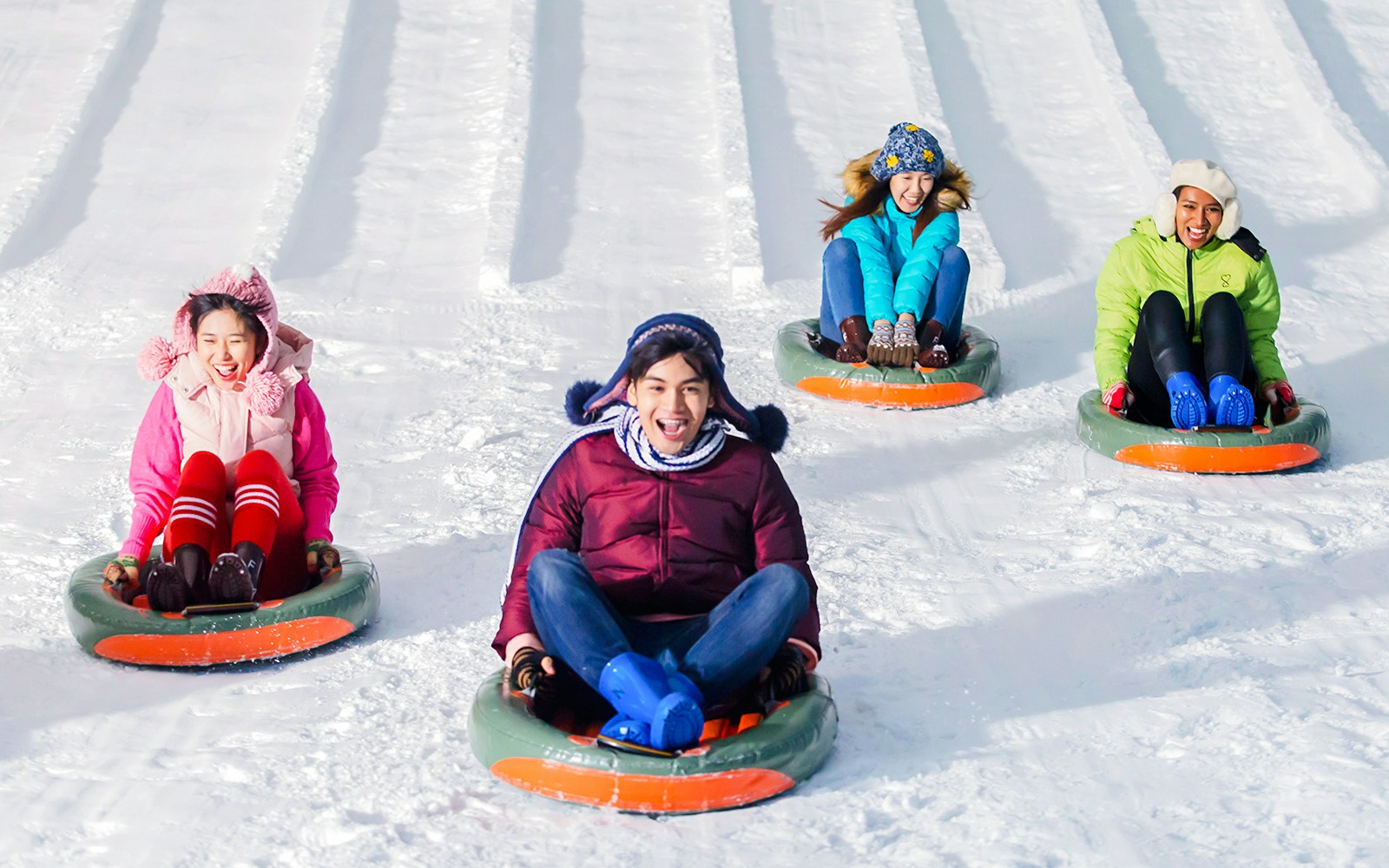 People sledding on snow at Snow Town, Dreamworld Bangkok.