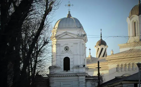Historic church tower and dome in Bucharest, part of the Road of Gold Mystery city exploration game.