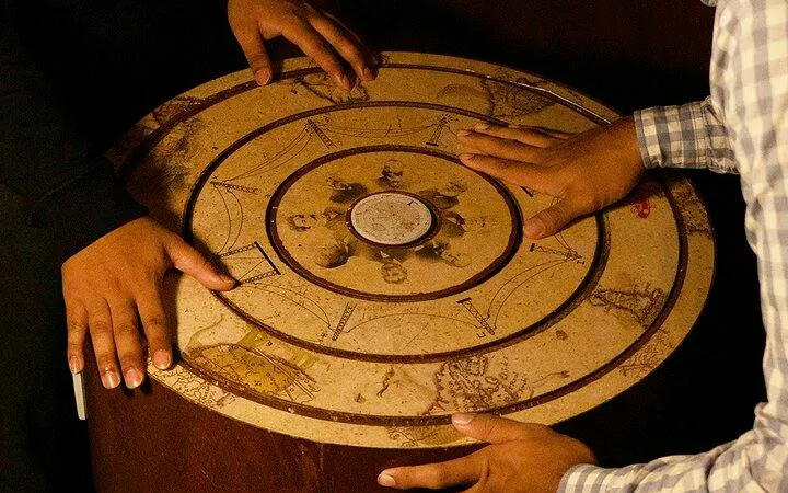 Hands on a puzzle table in the Chamber of Hocus escape room, Breakout Avenue K, Dubai.