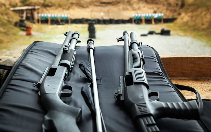 Shotguns on a bench at a shooting range in Krakow.