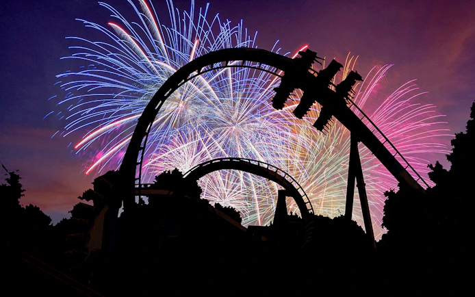 Roller coaster silhouette with fireworks at Busch Gardens Williamsburg.