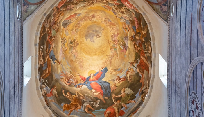 Interior fresco of Pisa Cathedral dome depicting religious figures and celestial scene.