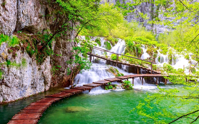 Wooden path over waterfalls at Plitvice Lakes National Park, Croatia.
