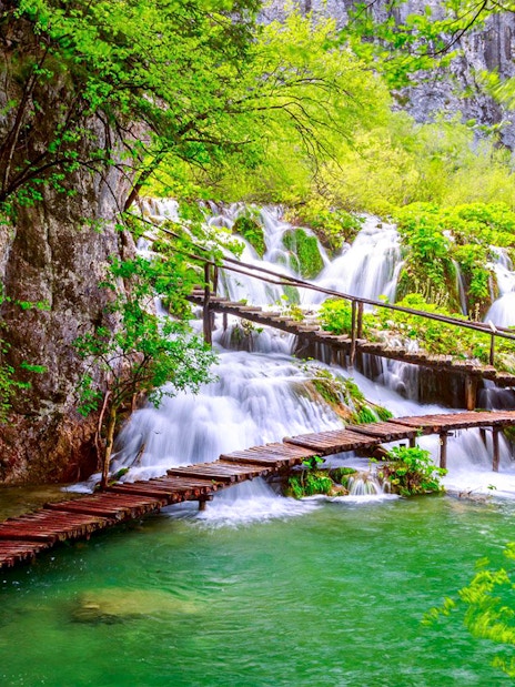 Wooden path over waterfalls at Plitvice Lakes National Park, Croatia.