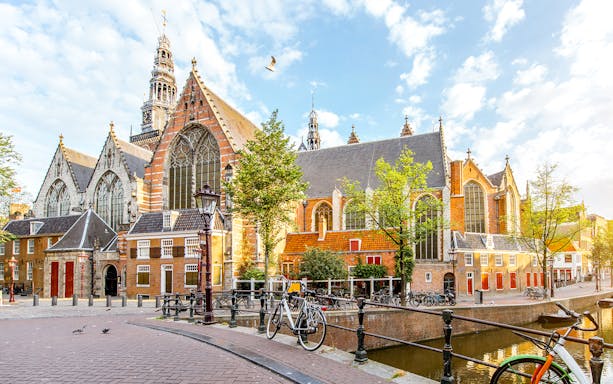 Oude Kerk in Amsterdam with bicycles along the canal.