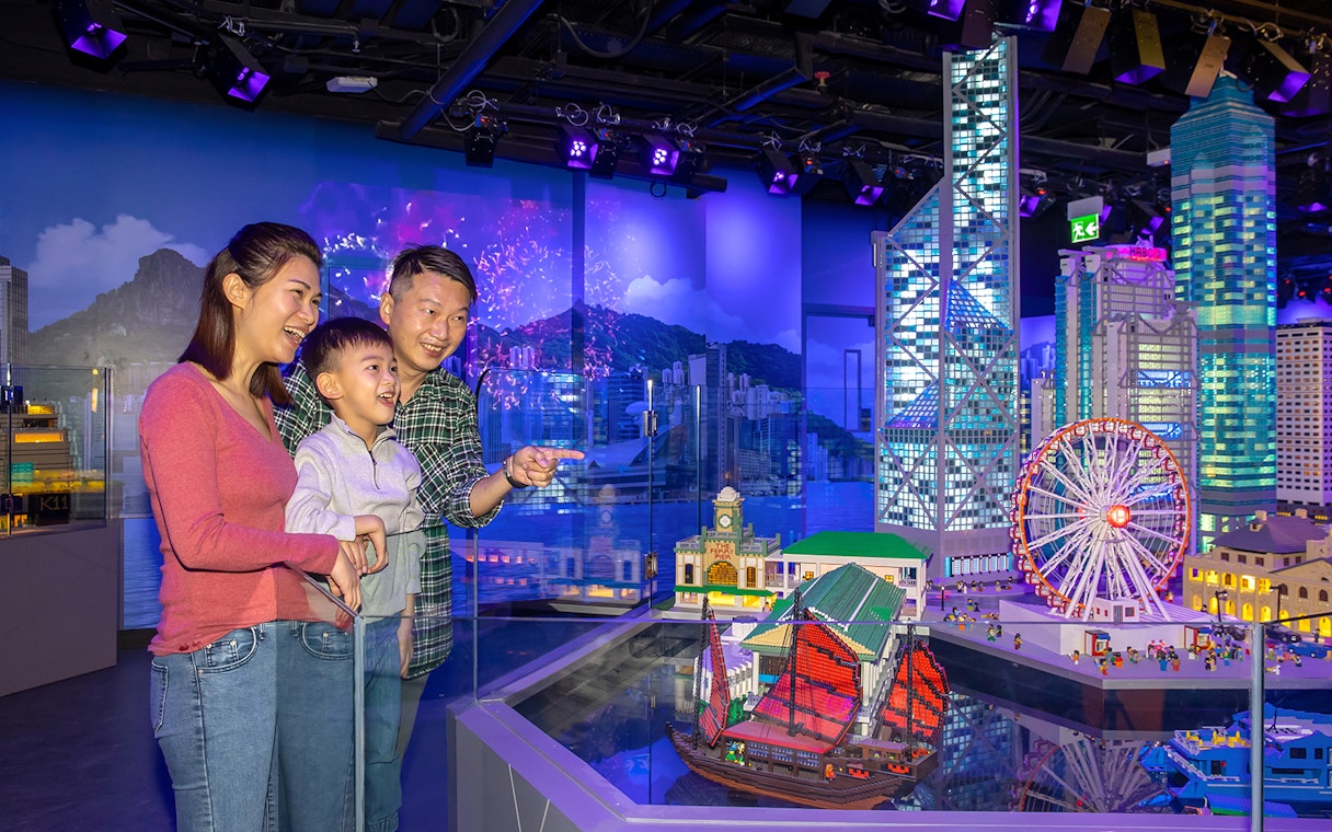 Family enjoying LEGO Hong Kong skyline display at LEGOLAND® Discovery Centre Hong Kong.