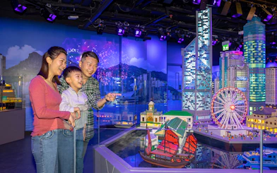 Family enjoying LEGO Hong Kong skyline display at LEGOLAND® Discovery Centre Hong Kong.