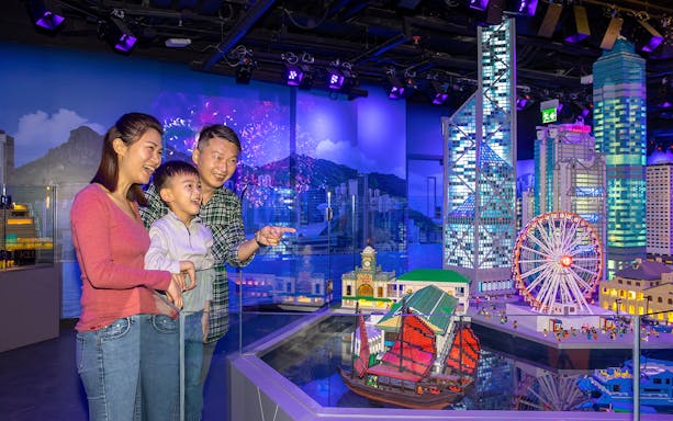 Family enjoying LEGO Hong Kong skyline display at LEGOLAND® Discovery Centre Hong Kong.