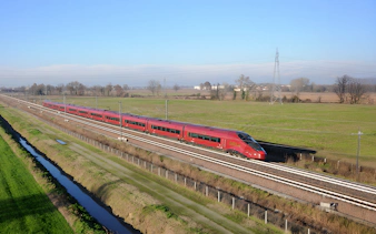 High-speed train traveling through countryside between Rome and Florence.