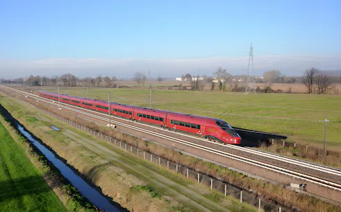 High-speed train traveling through countryside between Rome and Florence.