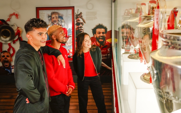 Guests viewing trophies at Liverpool Football Club Museum.