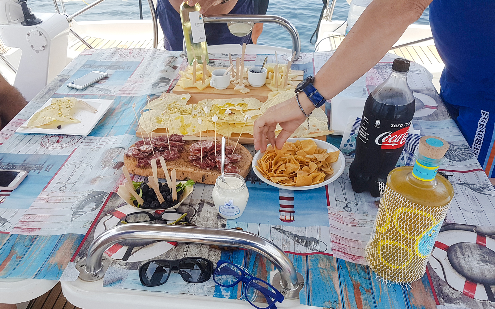 Sailboat excursion in La Maddalena Archipelago with snacks and drinks on deck.