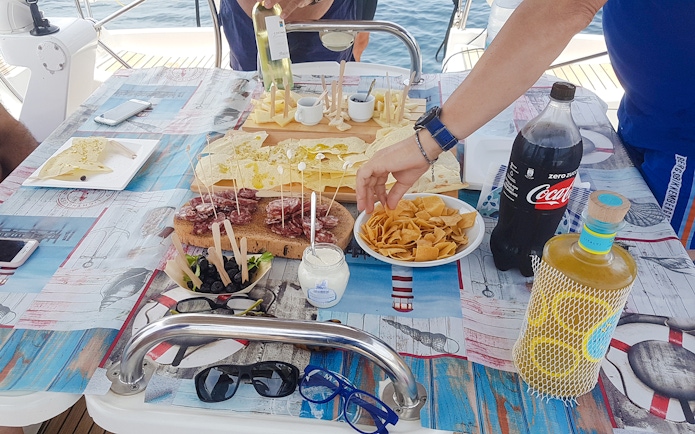 Sailboat excursion in La Maddalena Archipelago with snacks and drinks on deck.