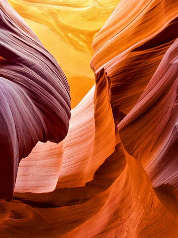 Antelope Canyon's swirling sandstone formations in vibrant orange and purple hues.