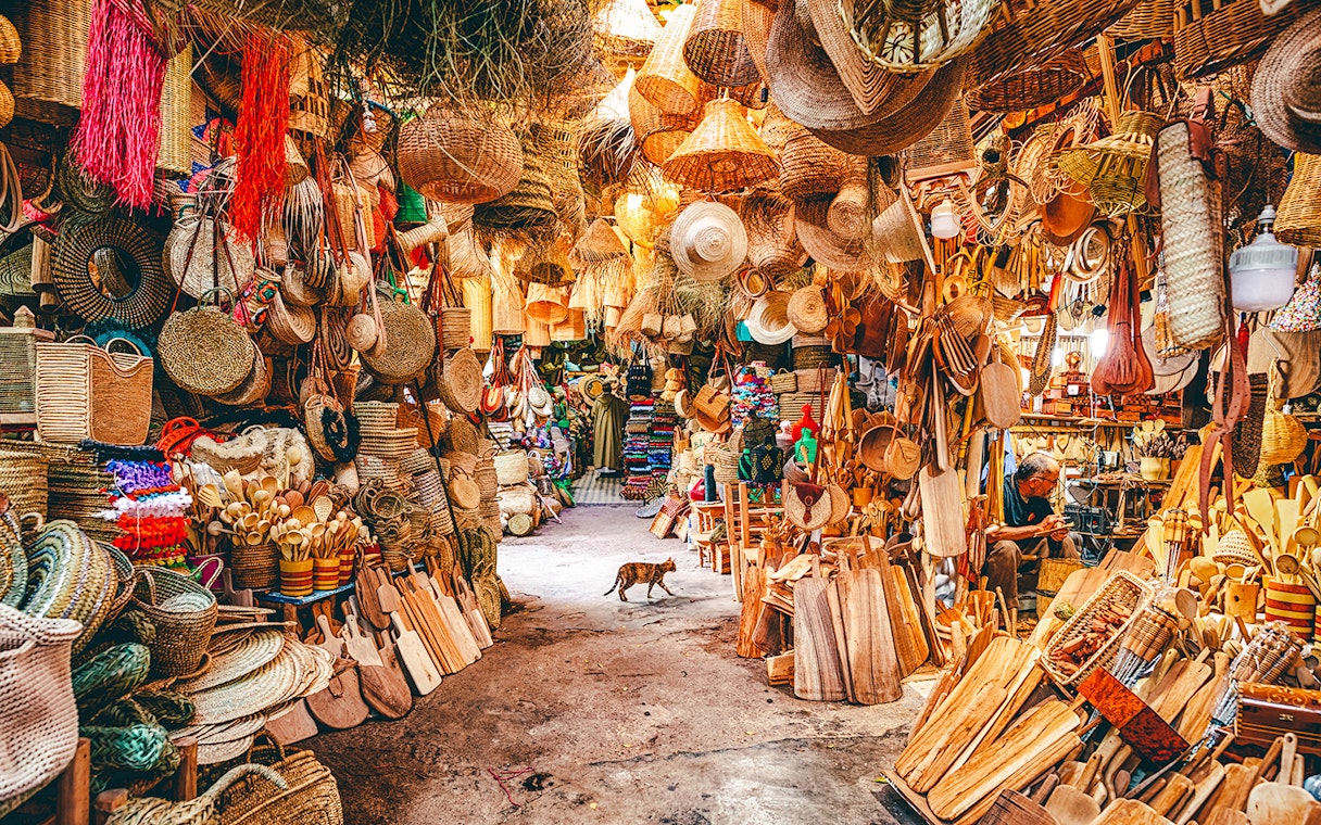 Baskets and wooden crafts displayed in a vibrant souk in Marrakech, Morocco.