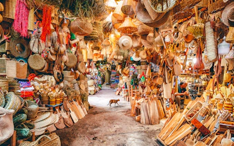 Baskets and wooden crafts displayed in a vibrant souk in Marrakech, Morocco.