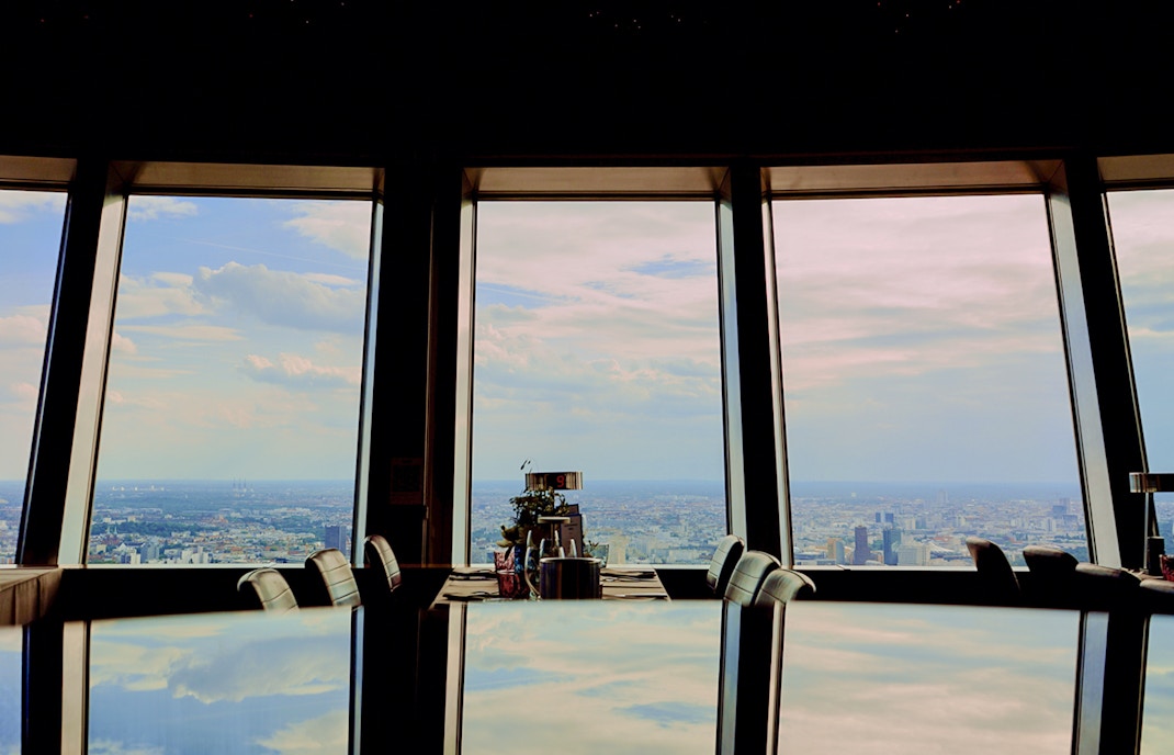 View from Berlin TV Tower restaurant overlooking cityscape.