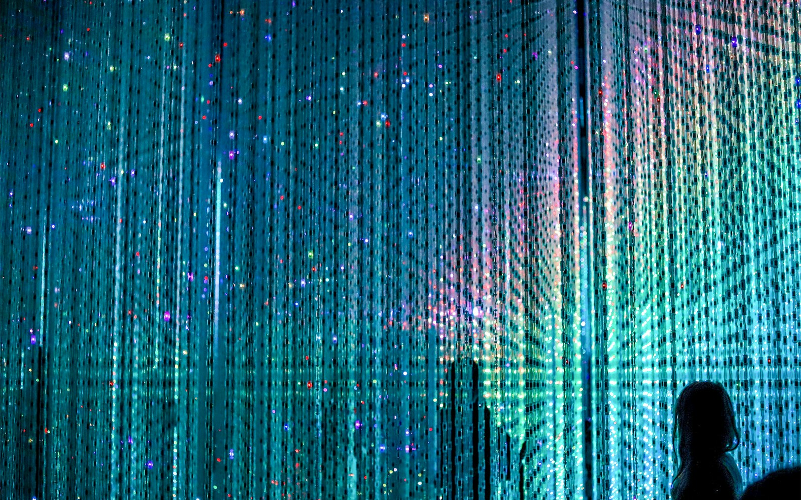 TeamLab Planets Tokyo immersive digital art installation with vibrant light displays.