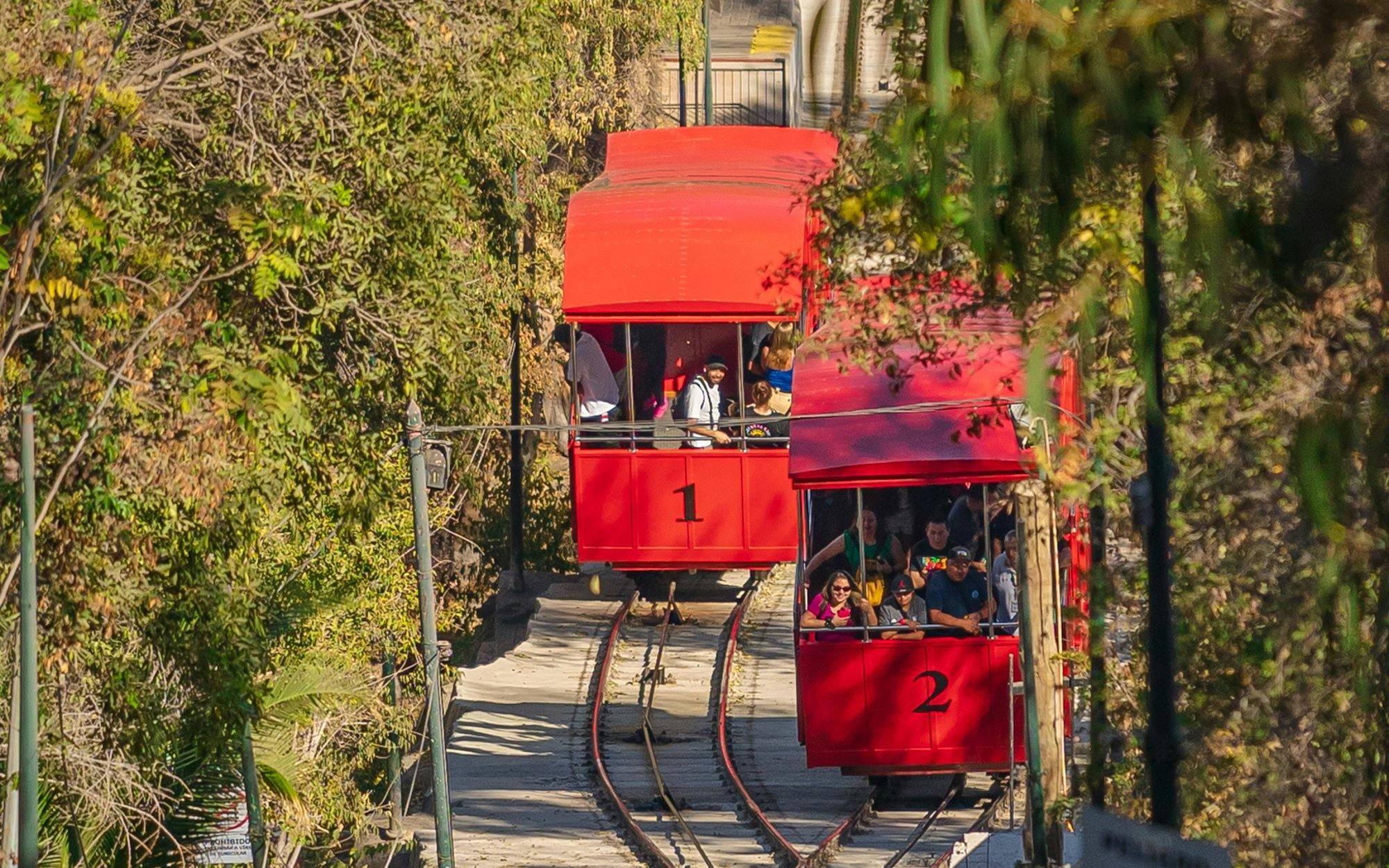 Funicular de Santiago cable cars on tracks surrounded by greenery in Santiago, Chile.