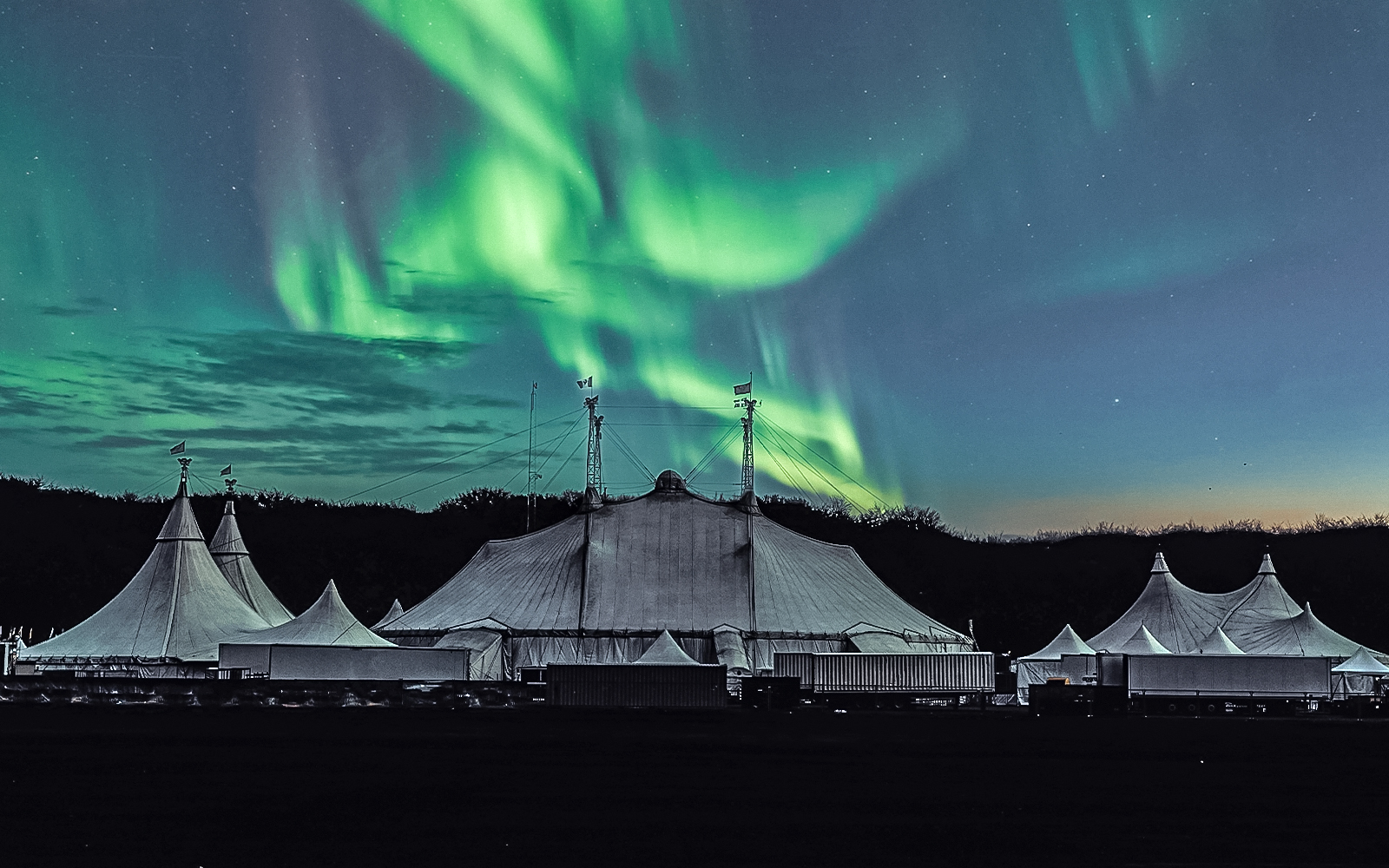 northern lights festival tent with northern lights in the sky