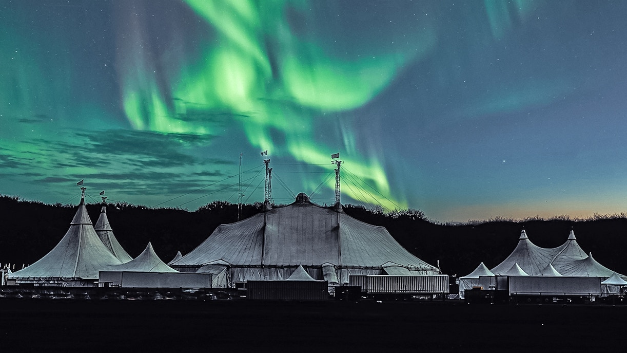 northern lights festival tent with northern lights in the sky