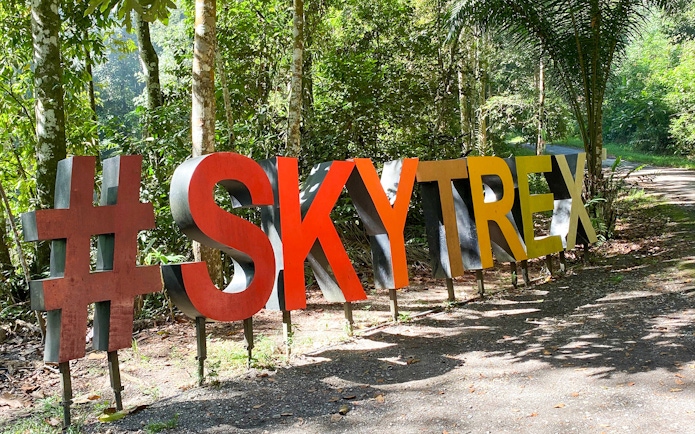 Skytrex Adventure Langkawi sign in lush forest setting.