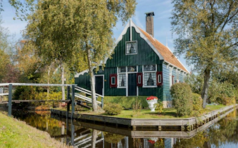 Traditional Dutch house by a canal in Zaanse Schans, Netherlands.